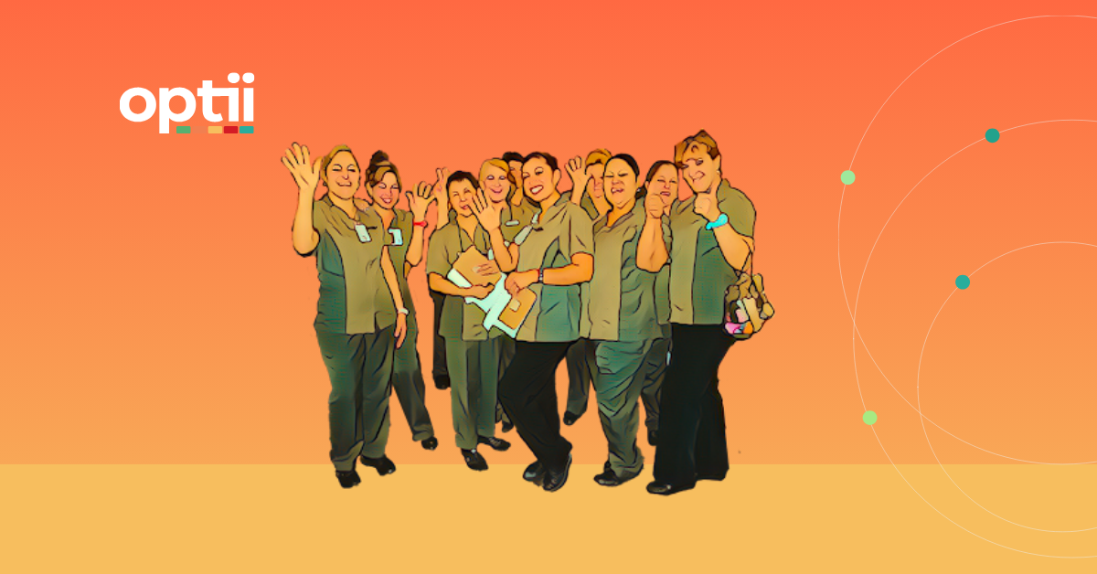 Group of smiling hotel housekeepers in uniform, representing teamwork and staff retention supported by housekeeping software.